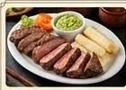 Cortes de carne en vara servidos sobre tabla de madera